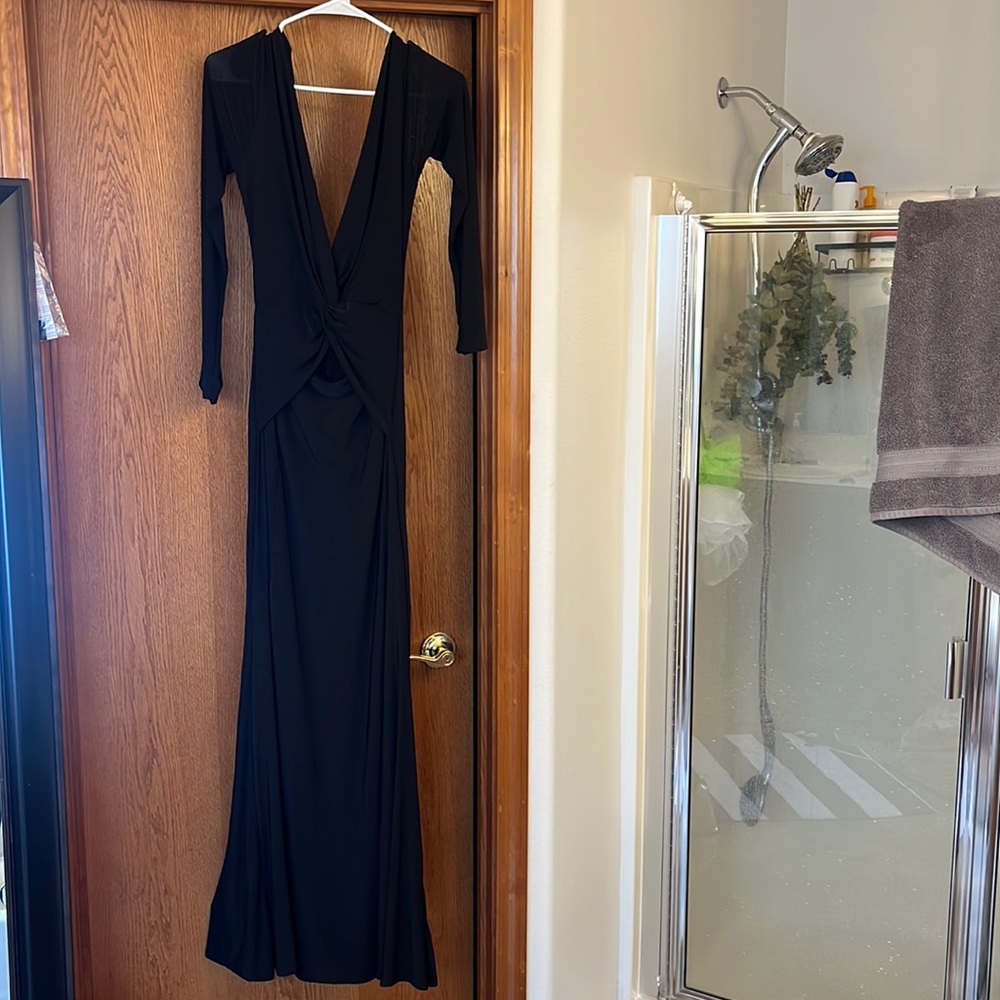 Long black dress. Open back and little opening on stomach